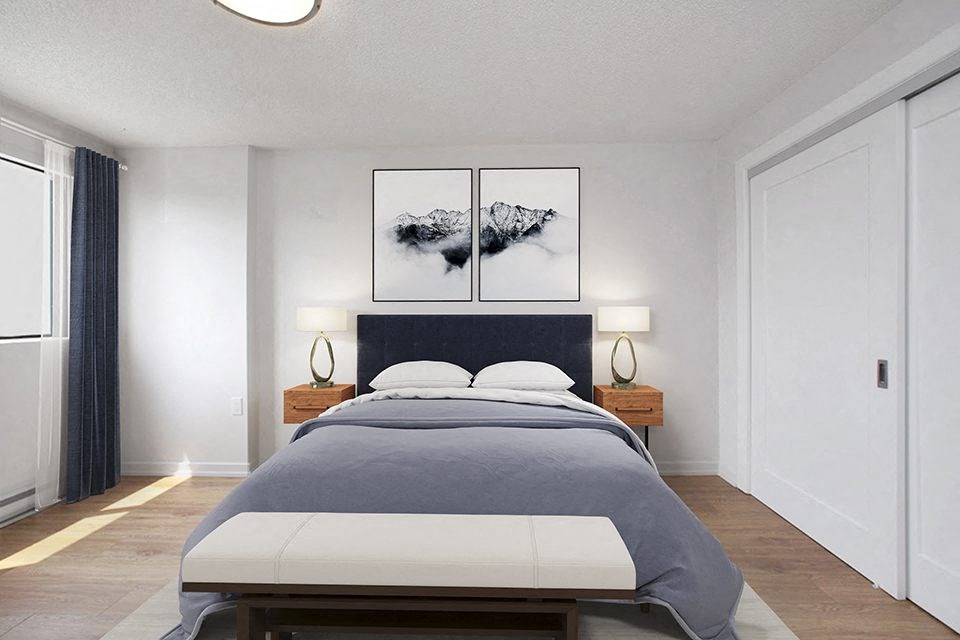 Second bedroom with a queen size bed and nightstands at Riverbend Tower Apartments in Chatham, ON