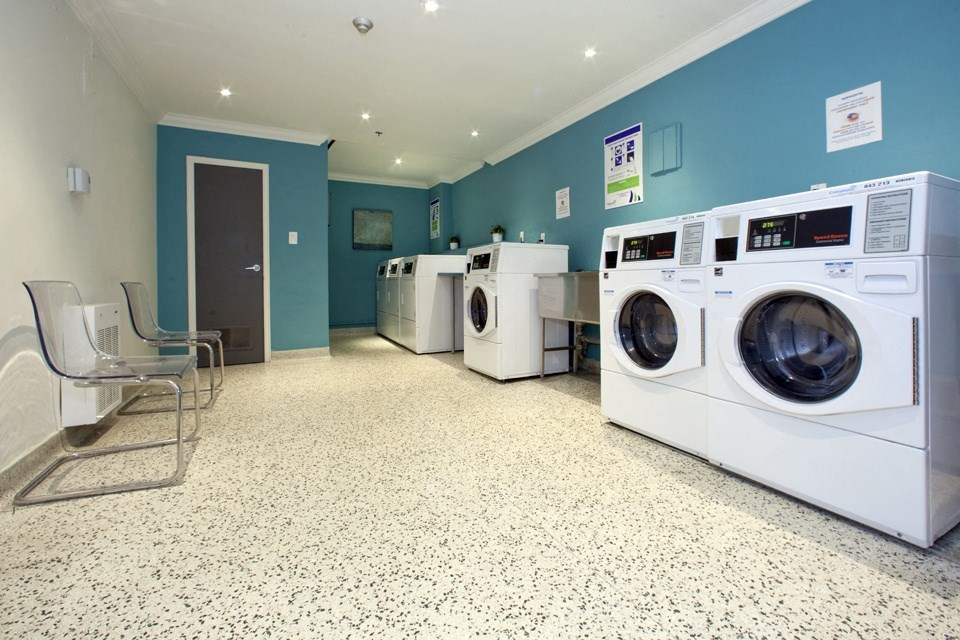 Rockliffe Park Suites on-site laundry facility featuring front load machines in Oakville, ON