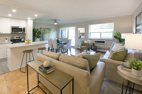 a living room and kitchen with a couch and a table