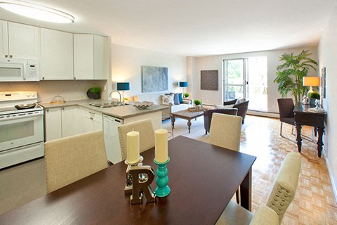 a kitchen and living room with a table and chairs