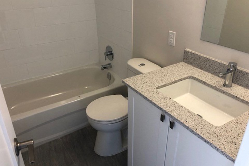 San Remo/Monaco in Toronto, ON bathroom with full sized bathtub, modern cabinetry and countertop