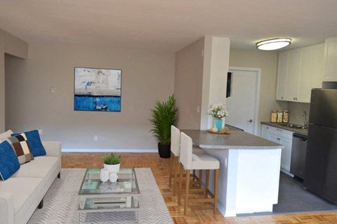 A modern kitchen with a dining table and chairs.