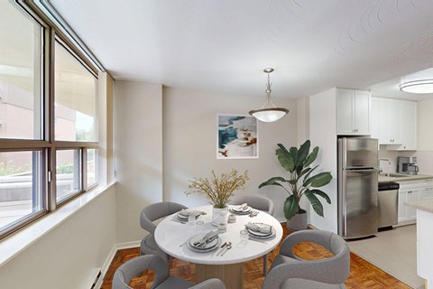 A dining room with a table set for four in a renovated 2 bed 1.5 bath suite at Somerset Place in London, ON.