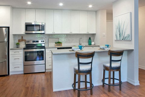 a kitchen with an island and two chairs
