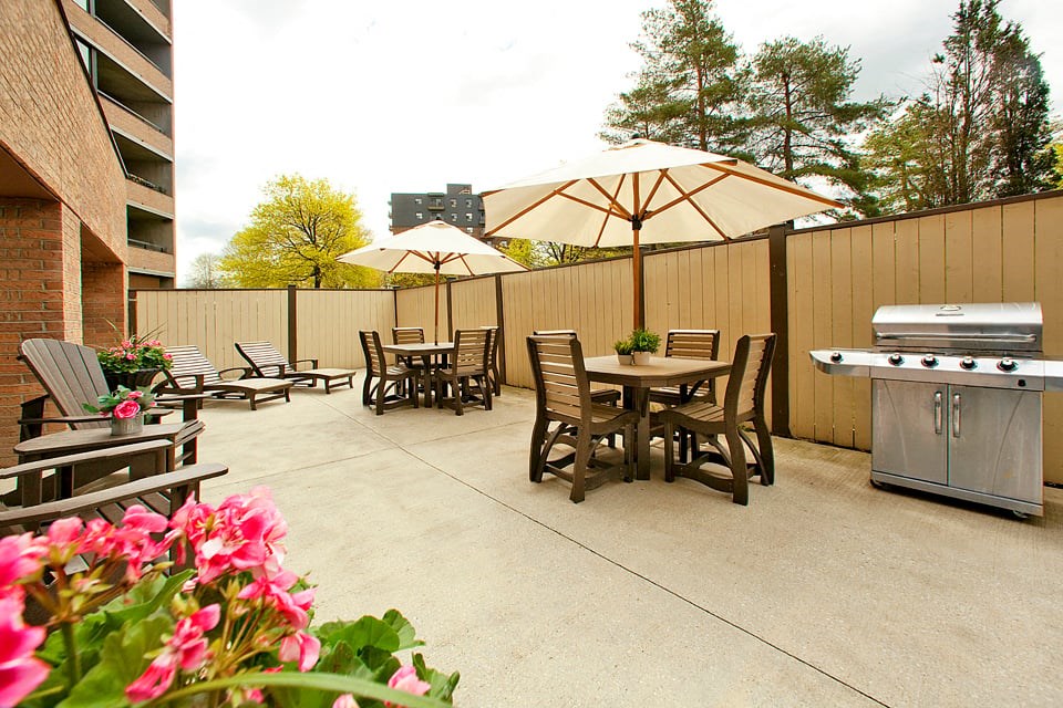 Springbank Apartments in London, ON outdoor patio with seating and BBQ