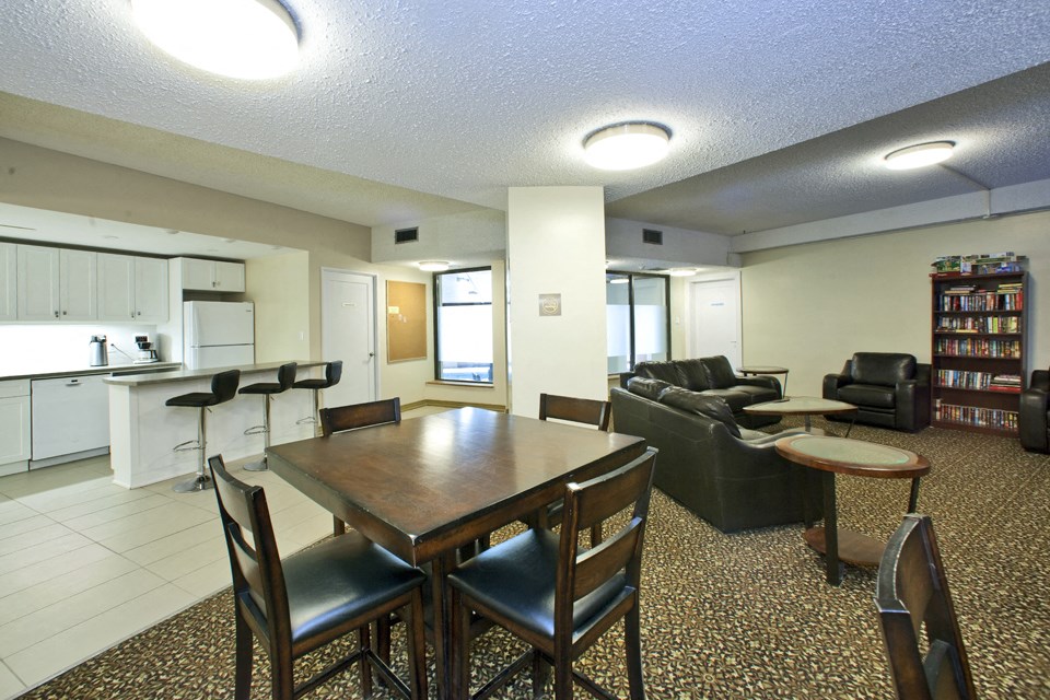Springbank Apartments social room with dining table and full kitchen in London, ON