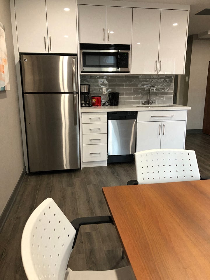 St. Augustine Place social room kitchenette with stainless steel appliances in St. Catharines, ON
