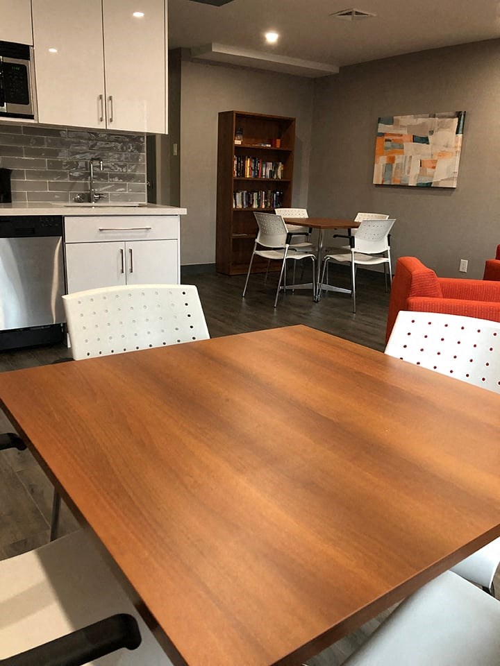 St. Augustine Place social room with tables and chairs in St. Catharines, ON