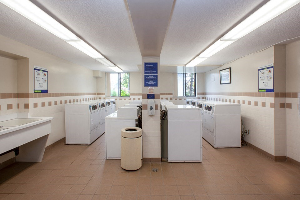 Sunnidale Place in Barrie, ON shared laundry space with several washing machines and dryers
