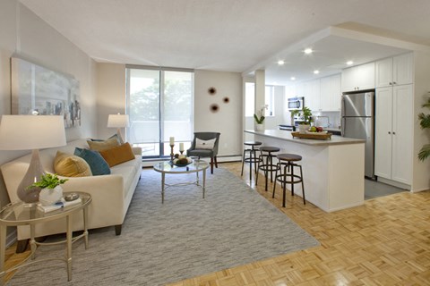 a living room and kitchen with a couch and a table