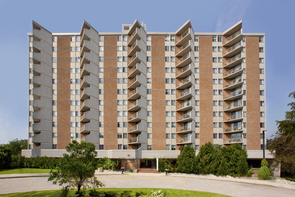 Sunset Towers building exterior showing straight on view with balconies and driveway in St. Thomas, ON