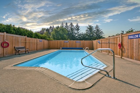 Sunset Towers outdoor pool with full-enclosed wood fence in St. Thomas, ON