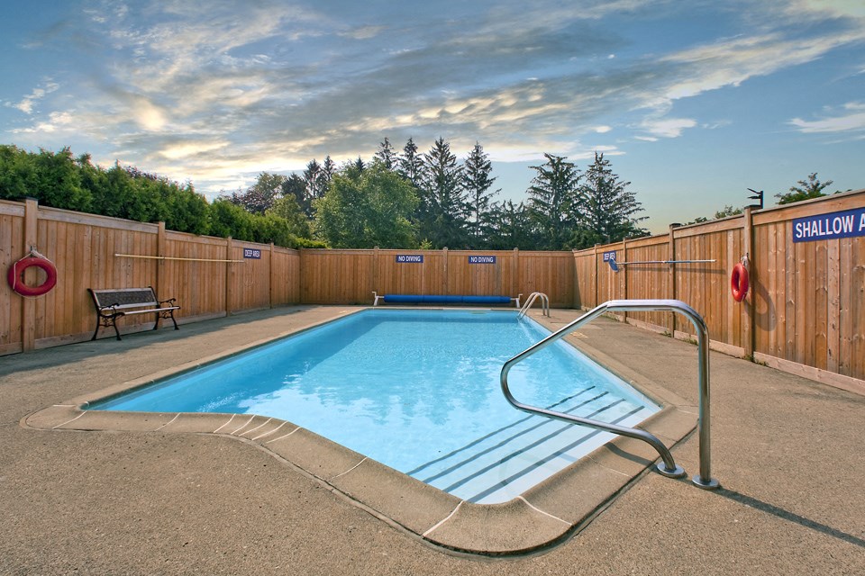Sunset Towers outdoor pool with full-enclosed wood fence in St. Thomas, ON