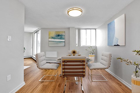 Sunset Towers dining room with table and four chairs, showing view from kitchen in St. Thomas, ON