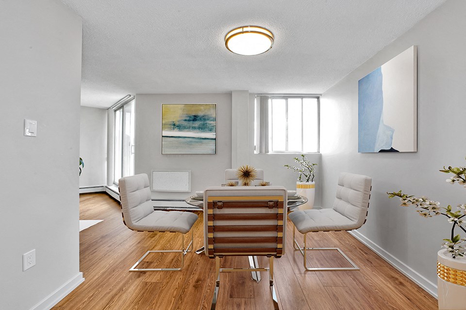Sunset Towers dining room with table and four chairs, showing view from kitchen in St. Thomas, ON