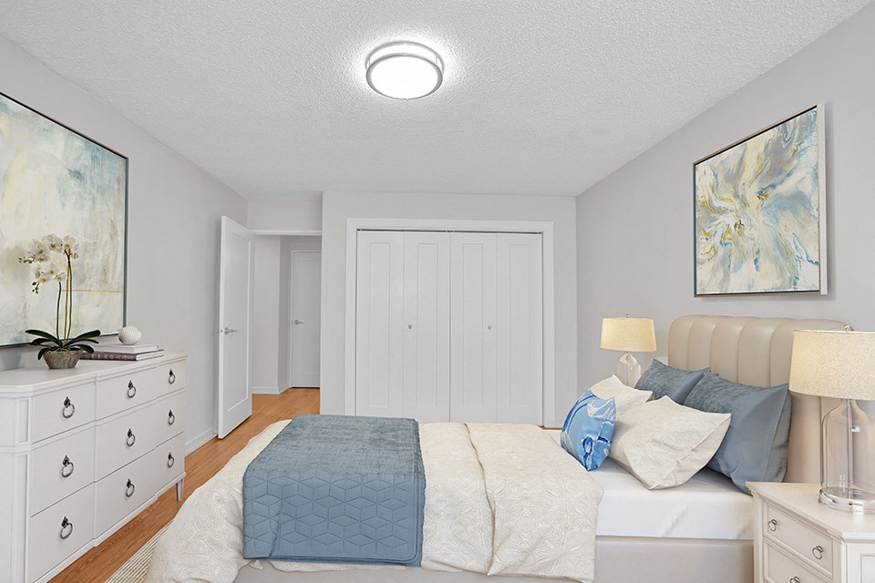 Sunset Towers primary bedroom with double-wide closet. Includes queen bed, two nightstands and dresser in St. Thomas, ON