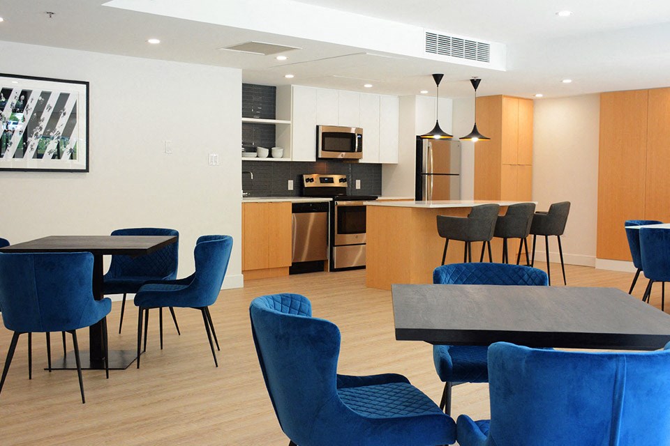Surrey Village social room featuring banquet seating and catering kitchen in Surrey, BC