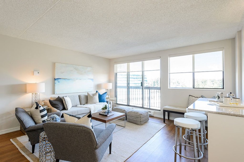 a living room with a couch and a bar Surrey Village Apartments in Surrey BC
