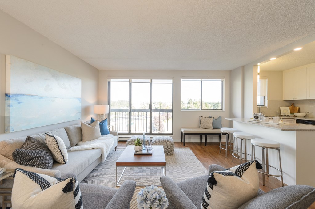 a living room with a couch and a table at Surrey Village in Surrey BC