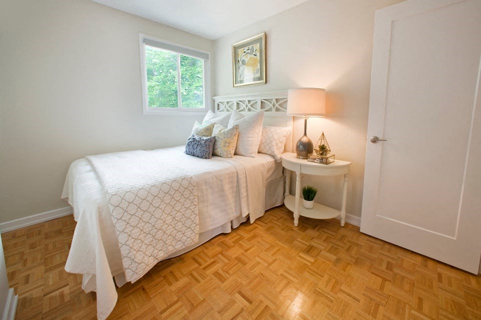 Tamarack Woods Breezy bedroom with windows and light white covers in Barrie, ON