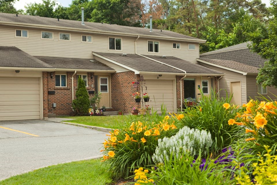 Tamarack Woods Townhouses with garage. Collection of natural flowers and greenery to the right in Barrie, ON