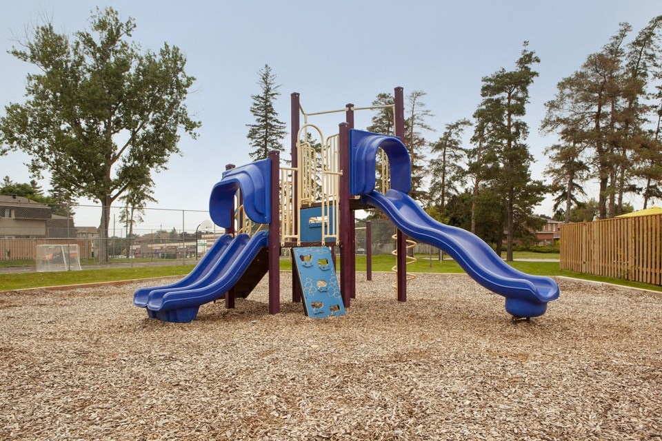 Tamarack Woods playground, showing play structure with slides and climbing wall in Barrie, ON