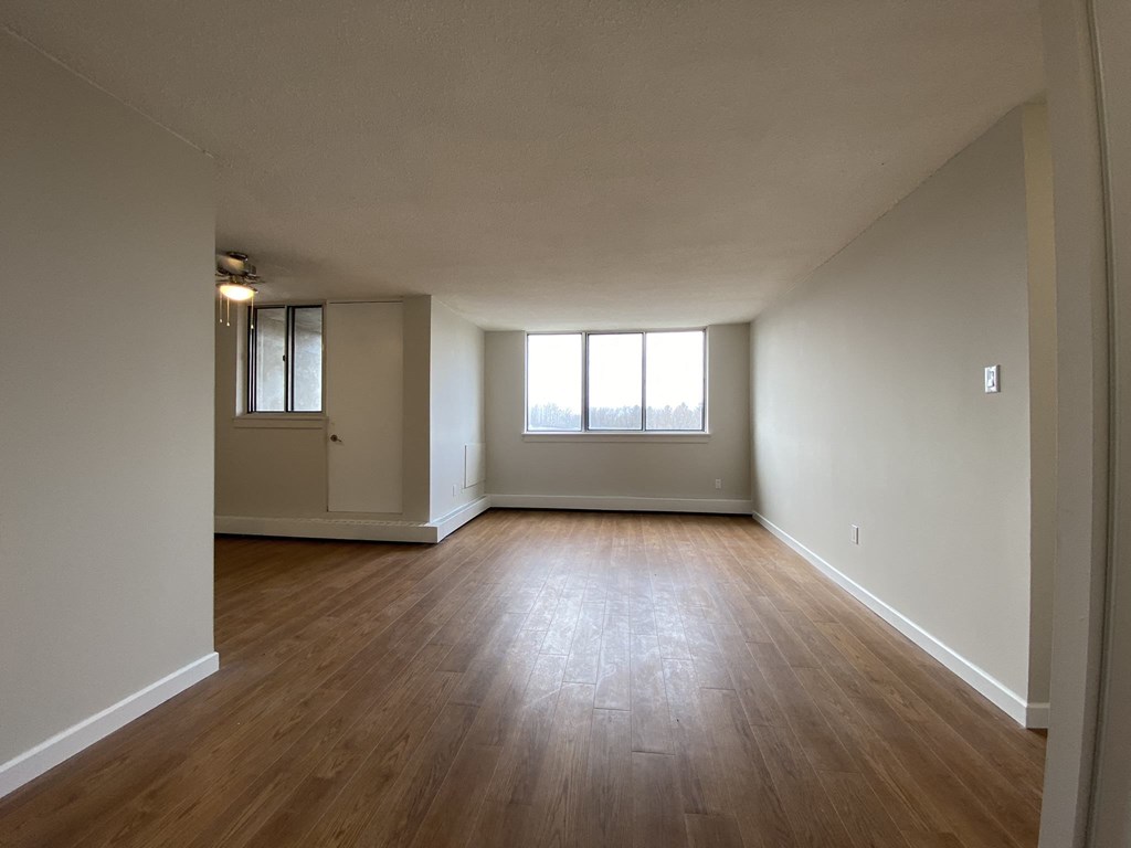 Living room at Tarawood Place in Peterborough, ON looking towards window and balcony door from entry way