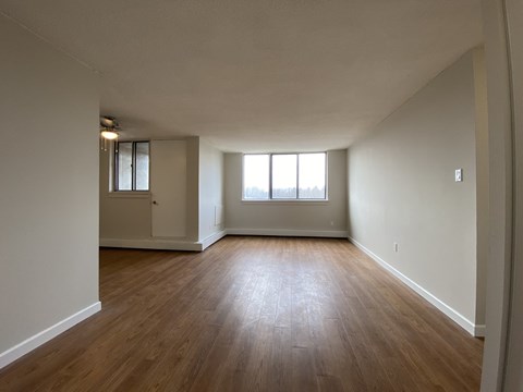Living room at Tarawood Place in Peterborough, ON looking towards window and balcony door from entry way