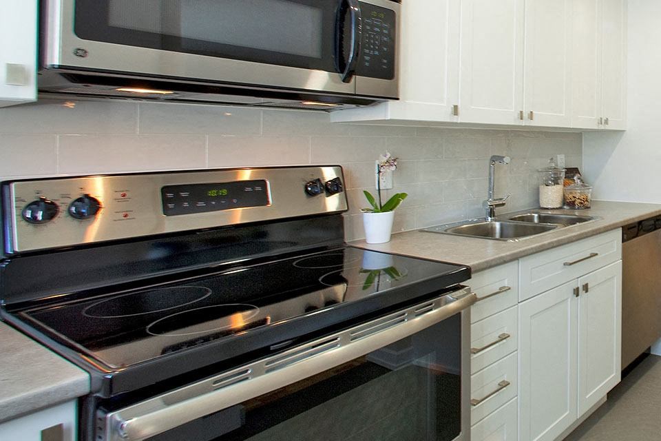 Taunton Terrace kitchen with full range stove and over-the-range microwave