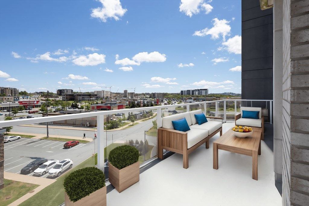 a balcony with two couches and a table