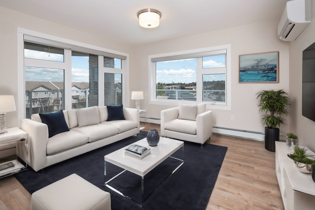 a living room with white couches and a coffee table
