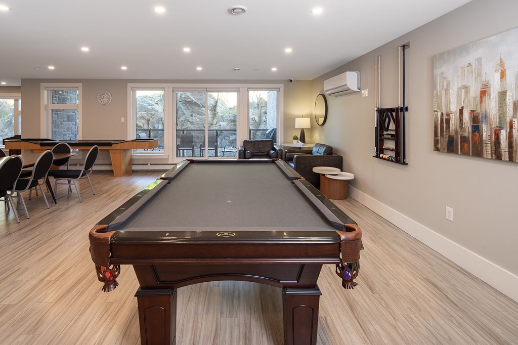 a pool table in the center of a living room with a billiards room