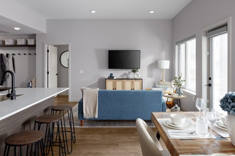 A modern kitchen with a blue sofa in the living room.