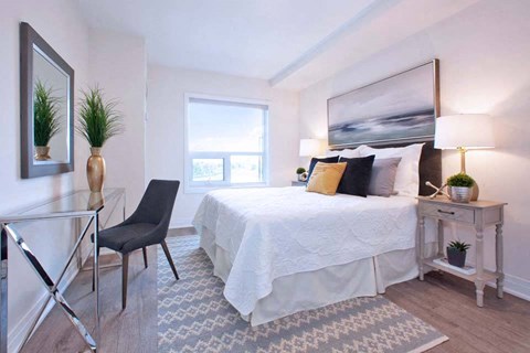 The Miltonian Apartments primary bedroom featuring work station in MIlton, ON