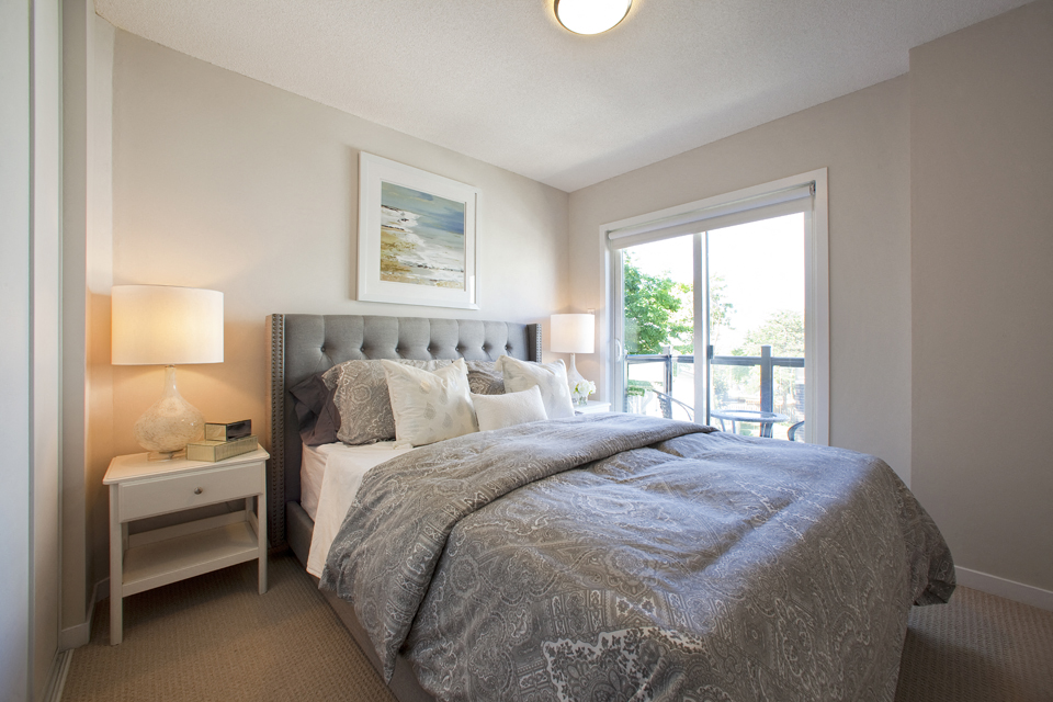 Towns on the Ravine Bedroom with grey covers and access to the balcony