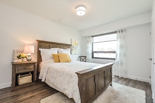 Trio On Belmont cozy bedroom with luxury plank flooring in Kitchener, ON