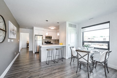a kitchen and dining room with a table and chairs