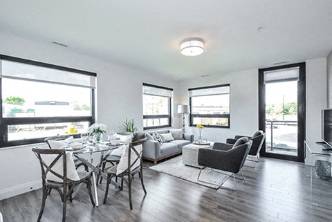 a living room and dining room with a table and chairs