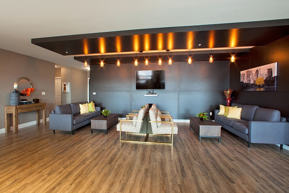 Penthouse resident's lounge with lounge seating and flat screen TV located in Building A at Trio on Belmont in Kitchener, ON