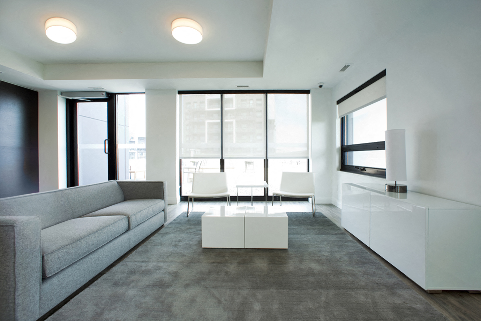 Trio On Belmont social room with big windows and seating area in Kitchener, ON