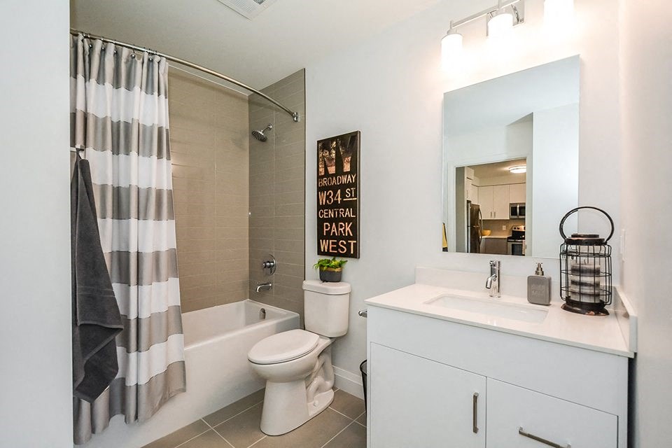 Bathroom with an oversized soaker tub, toilet and white vanity in a 1 bed 1 bath variation B in building A at Trio on Belmont in Kitchener, ON