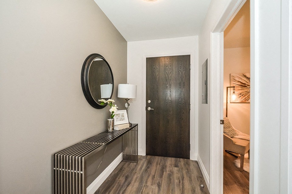 Entry area, with den to the right, in a 2 bed + den 2 bath variation E in building A at Trio on Belmont in Kitchener, ON