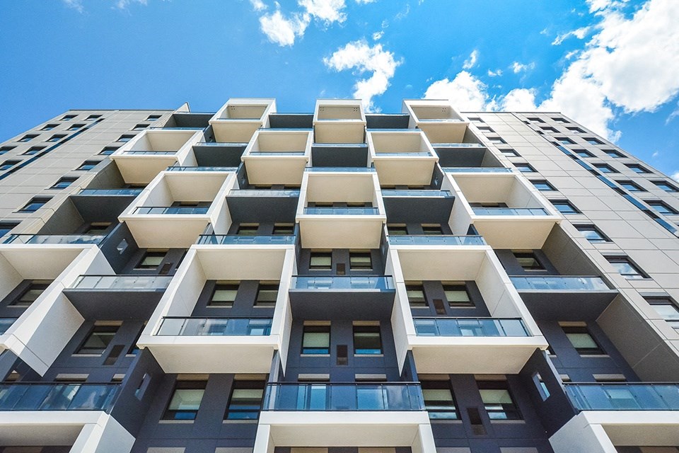Upward view, showing balconies and windows, of one of the buildings at Trio on Belmont in Kitchener, ON
