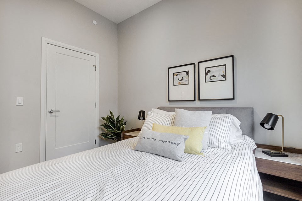 a bedroom with a bed and closet at Vale Station Apartments in Waterloo ON