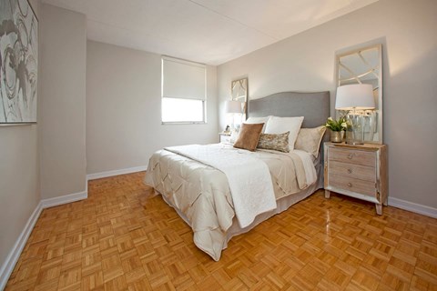 Valleyview Cozy bedroom with nightstand and long mirror on the right beside the bed in Newmarket, ON
