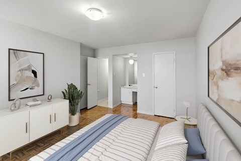 A white bedroom with a bed and a painting on the wall.