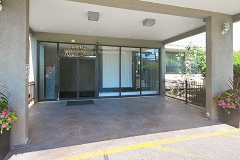 The entrance to a building with a glass door and a sign that reads "Gov. Village Hall".