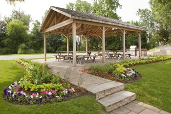 a gazebo with benches and tables at Acton Apartments in Acton ON