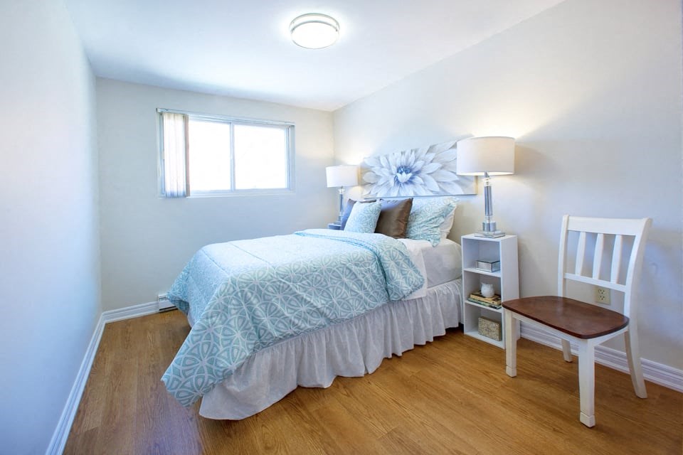 London Road Apartments large bedroom with hardwood flooring in Sarnia, ON