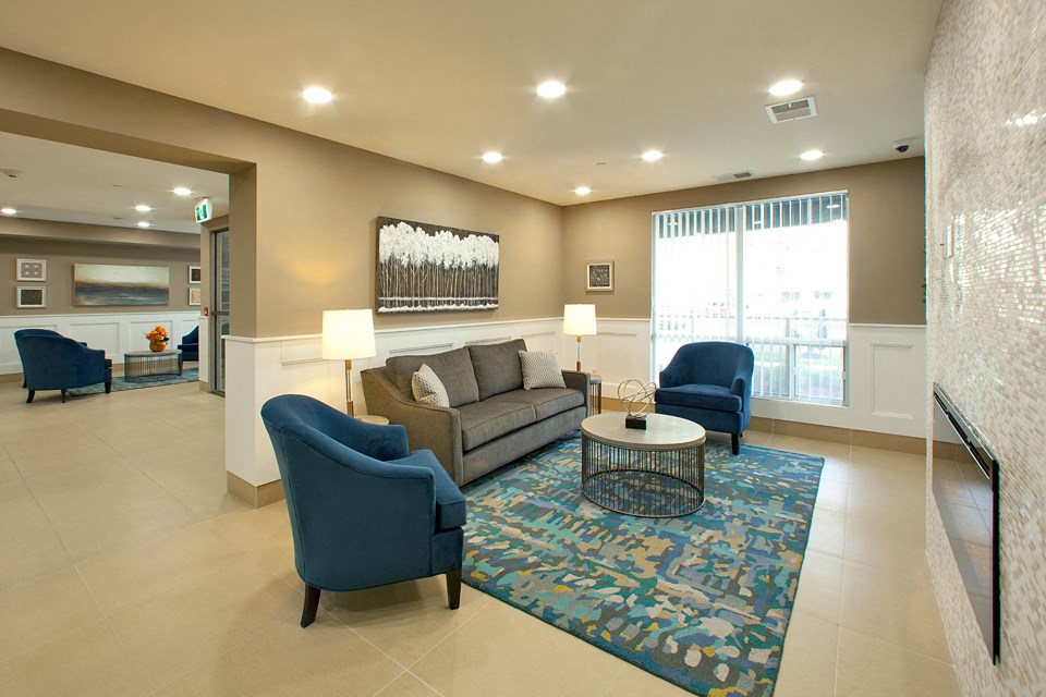 Juliana Place Apartments lobby featuring lounge seating and fireplace in Woodstock, ON